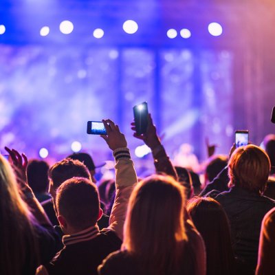People filming a music concert.