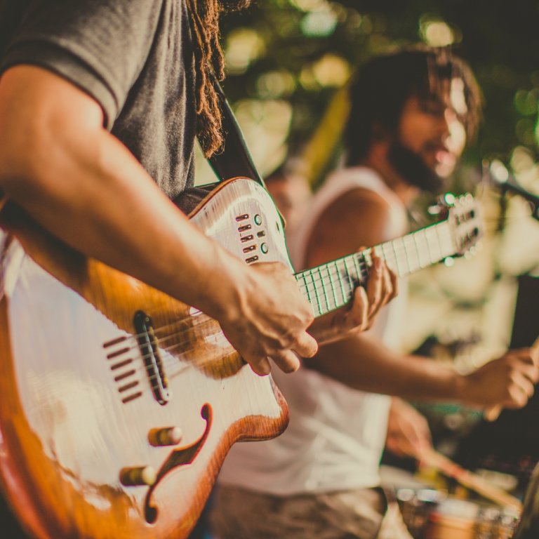 A man playing an electric guitar.