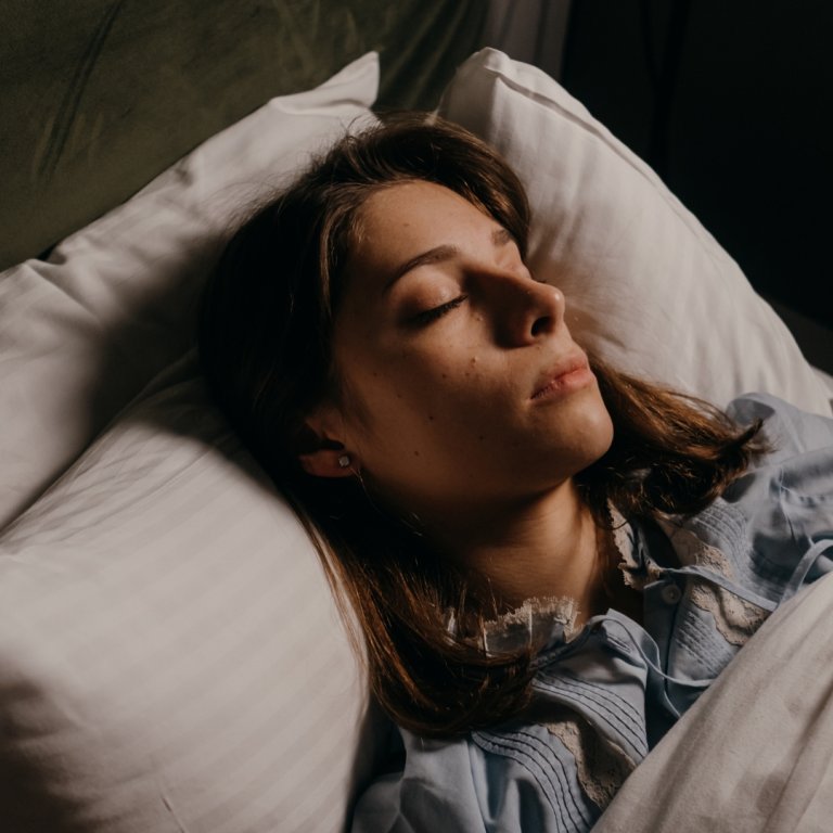 A woman sleeping in her bed.