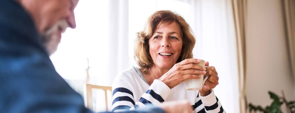 A couple talking and having tea.