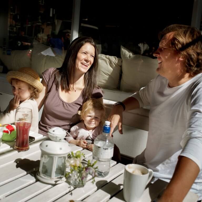 family-around-garden-seats-drinking-coffee