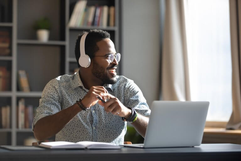 Aman at a desk with headphones on.