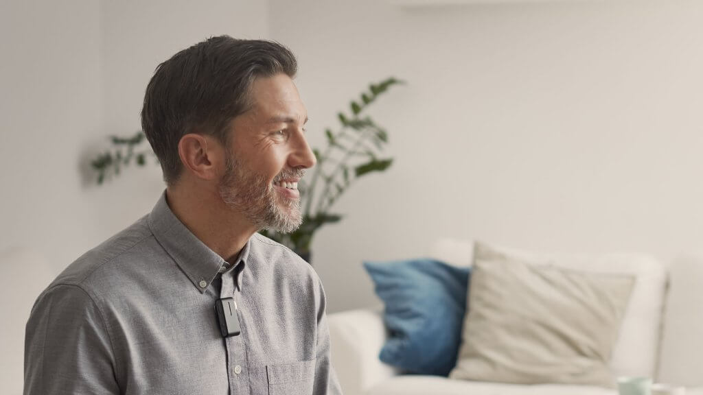 A man wearing a behind-the-ear hearing aids.