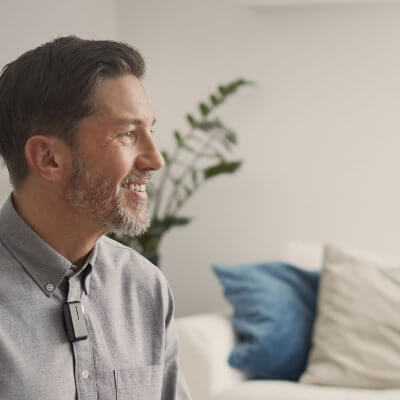 A man wearing a behind-the-ear hearing aids.