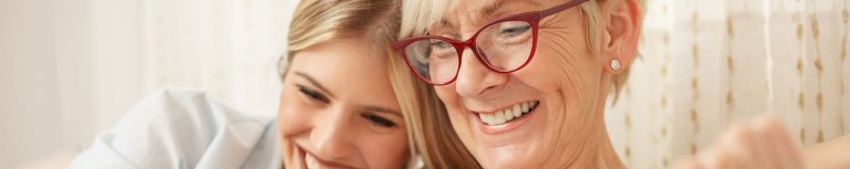 A mother and her daughter laughing.