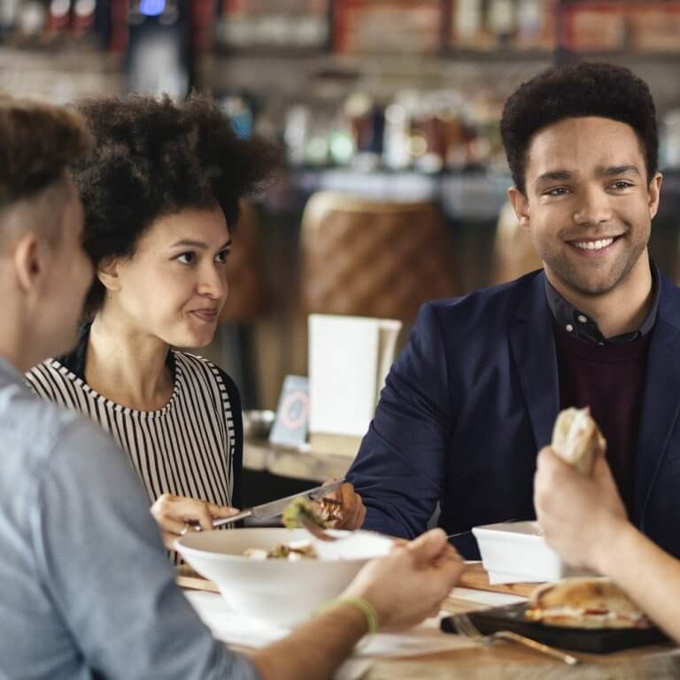 Friends talking and having fun at dinner party.