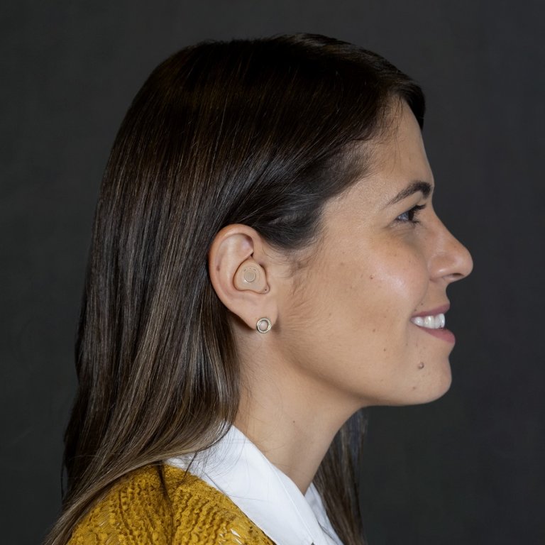 A woman wearing ReSound Custom hearing aids.