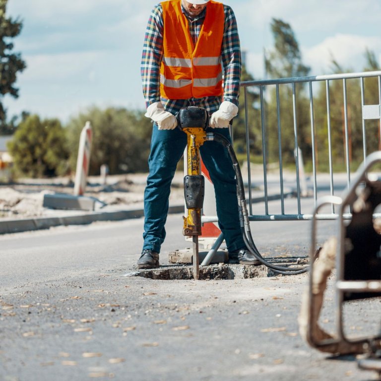 A worker using a jackhammer.