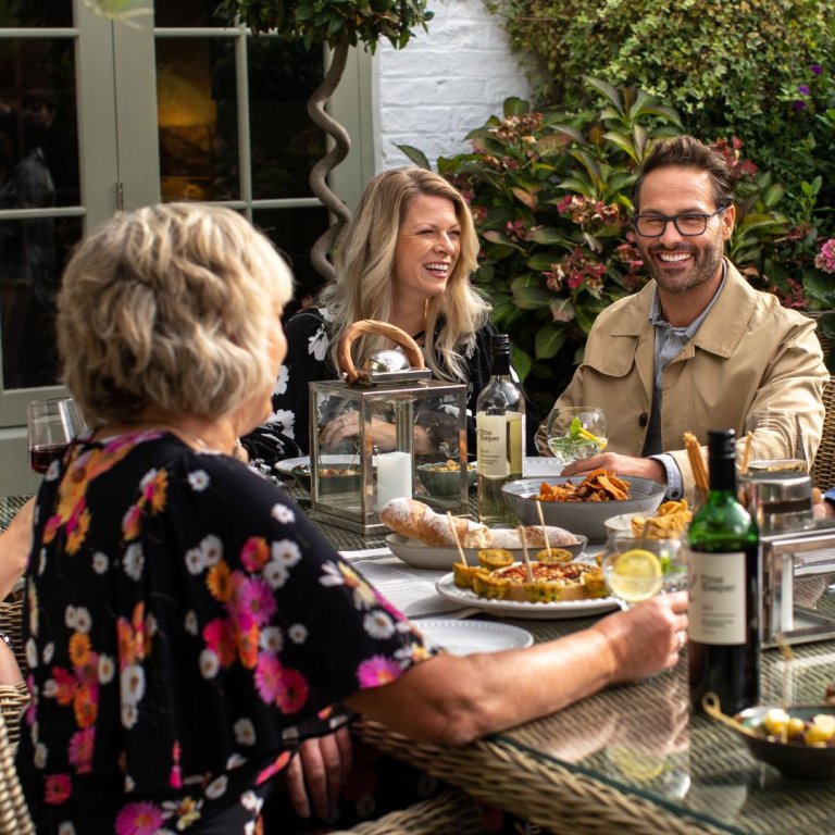 A family dinner on a table, outside.