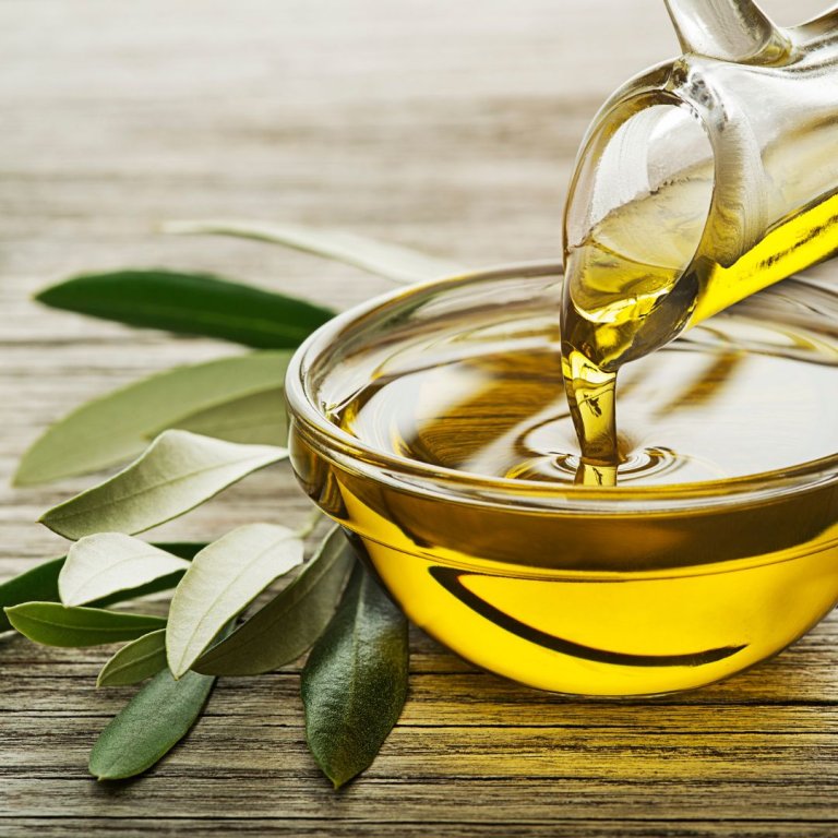 Olive oil and olive tree leaves.