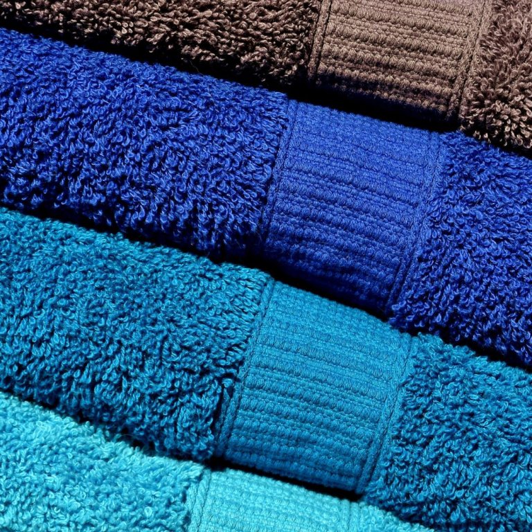 A close up image of four different coloured towels.