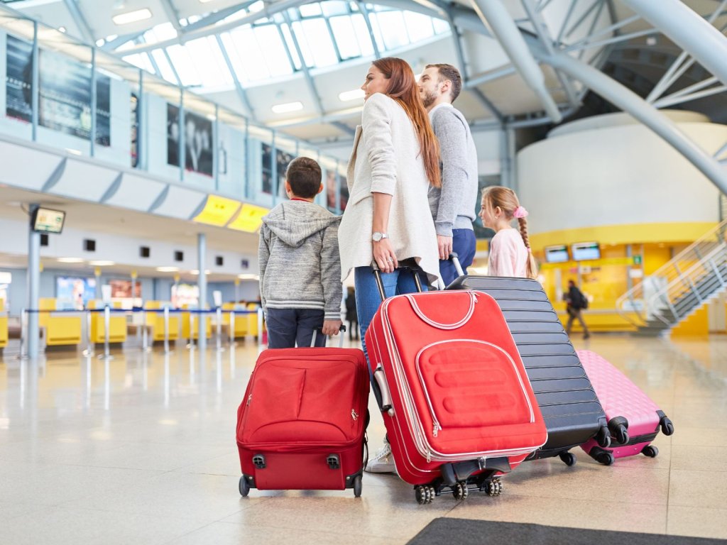 Family at the airport with luggage.