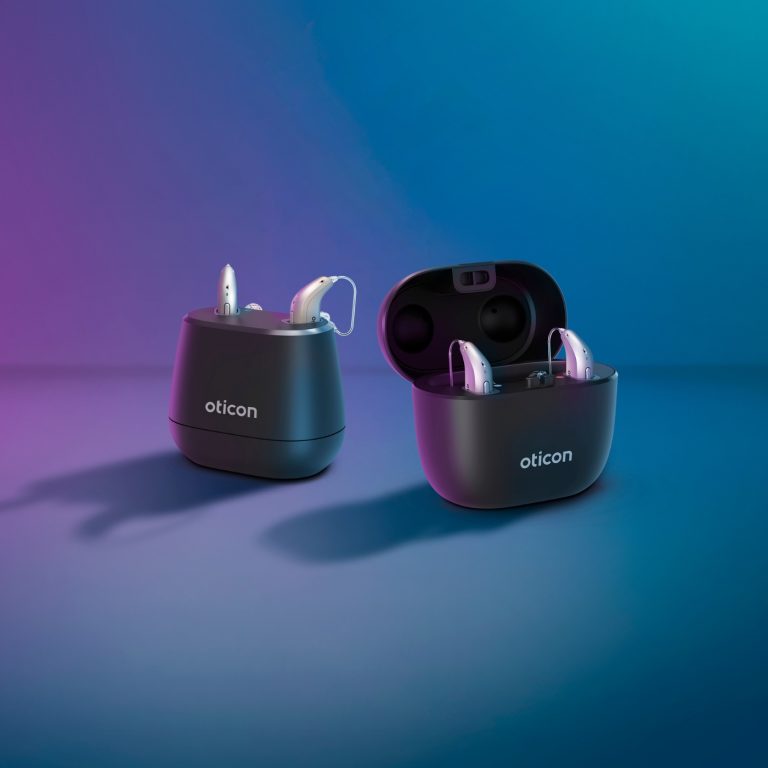 Hearing aid with desk charger or portable SmartCharger.