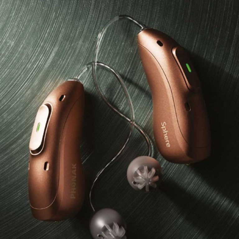 Two phonak EON hearing aids on a surface.
